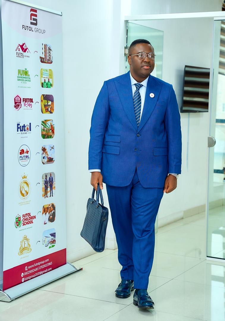 Prince Fuhad Oloto walking past the Futol Group banner