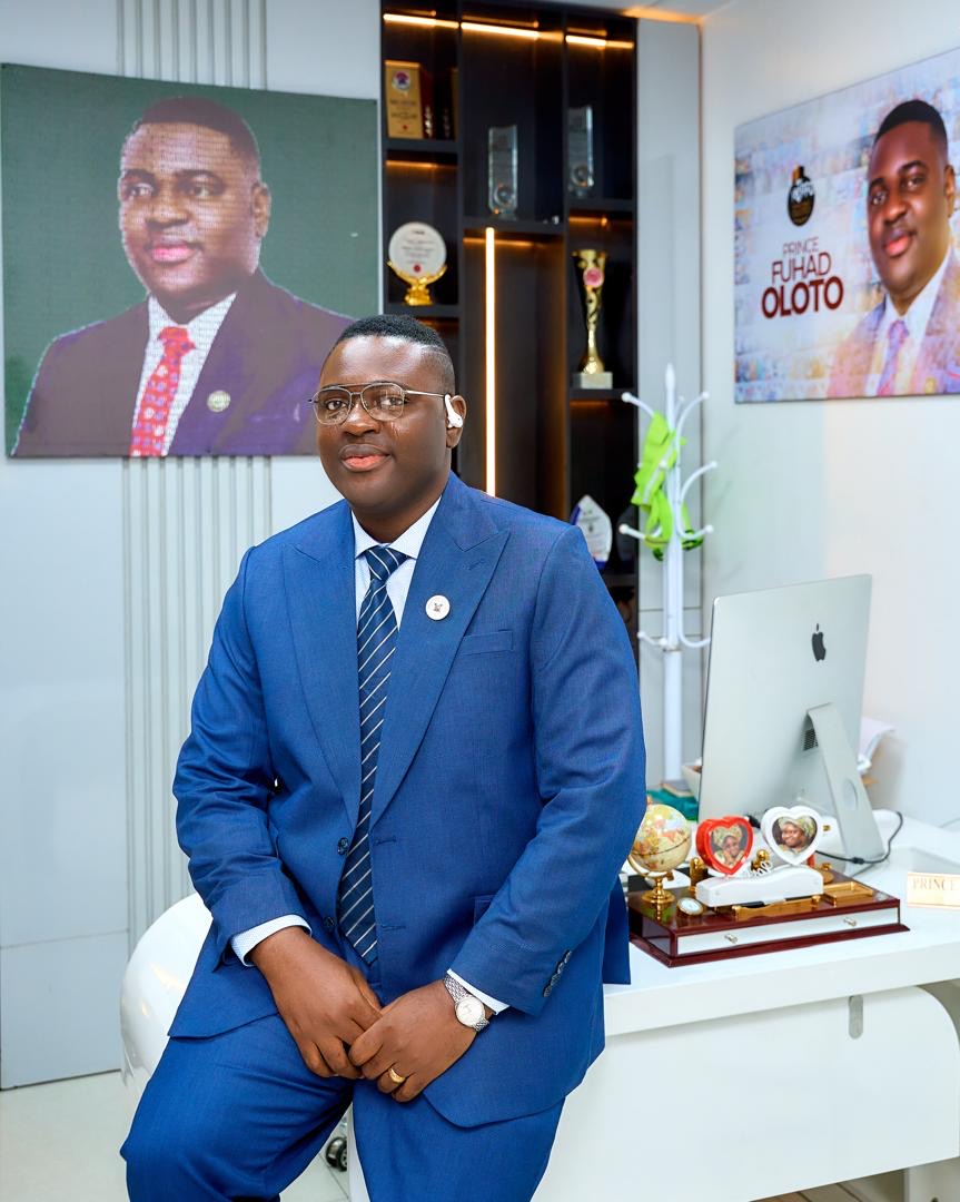Prince Fuhad Oloto leaning against his office desk