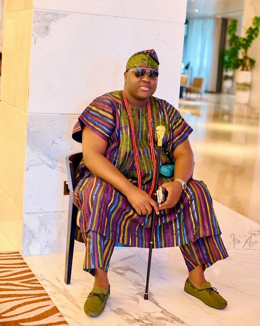 Prince Fuhad Oloto seated with a walking cane